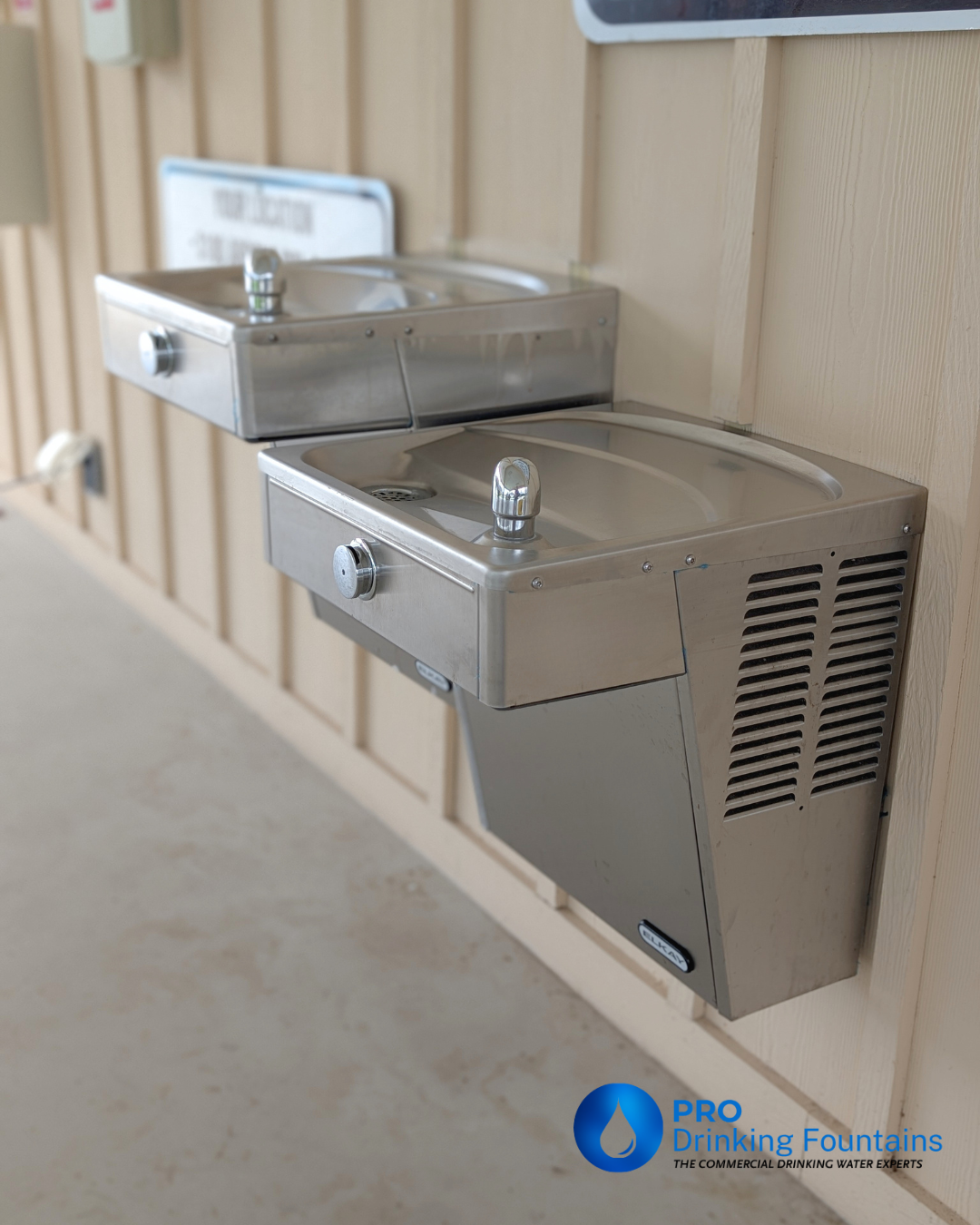 Outdoor drinking fountains mounted on a wall at a homeowners association