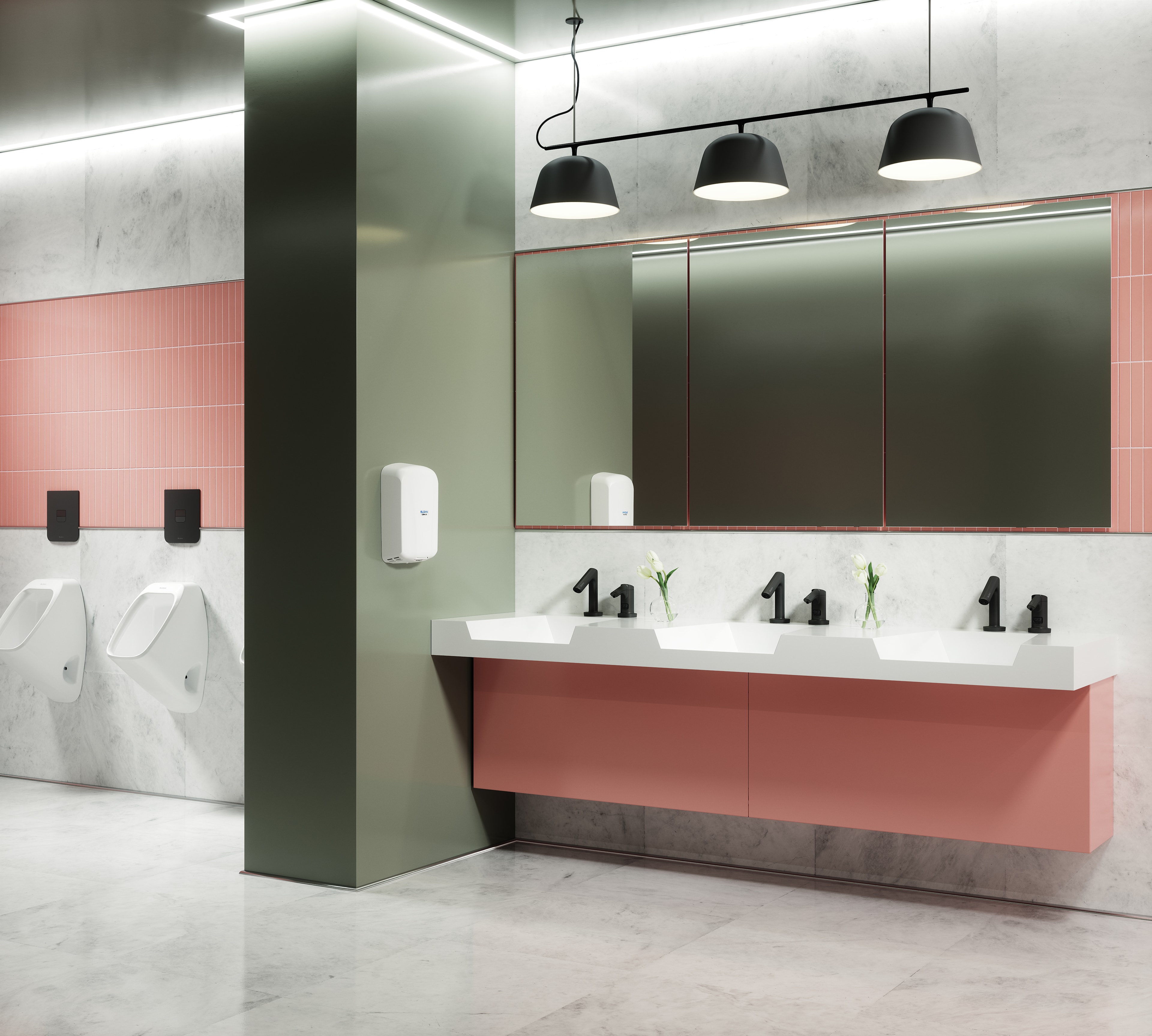 Modern commercial restroom with sage green and coral pink tile, marble surfaces, integrated sink countertop, and pendant lighting