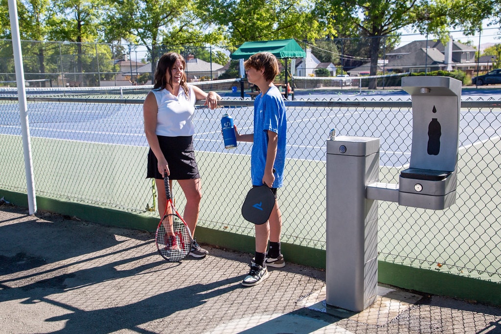 Tennis players at a Haws outdoor bottle filling station — Category Five Technologies Community Impact Initiative