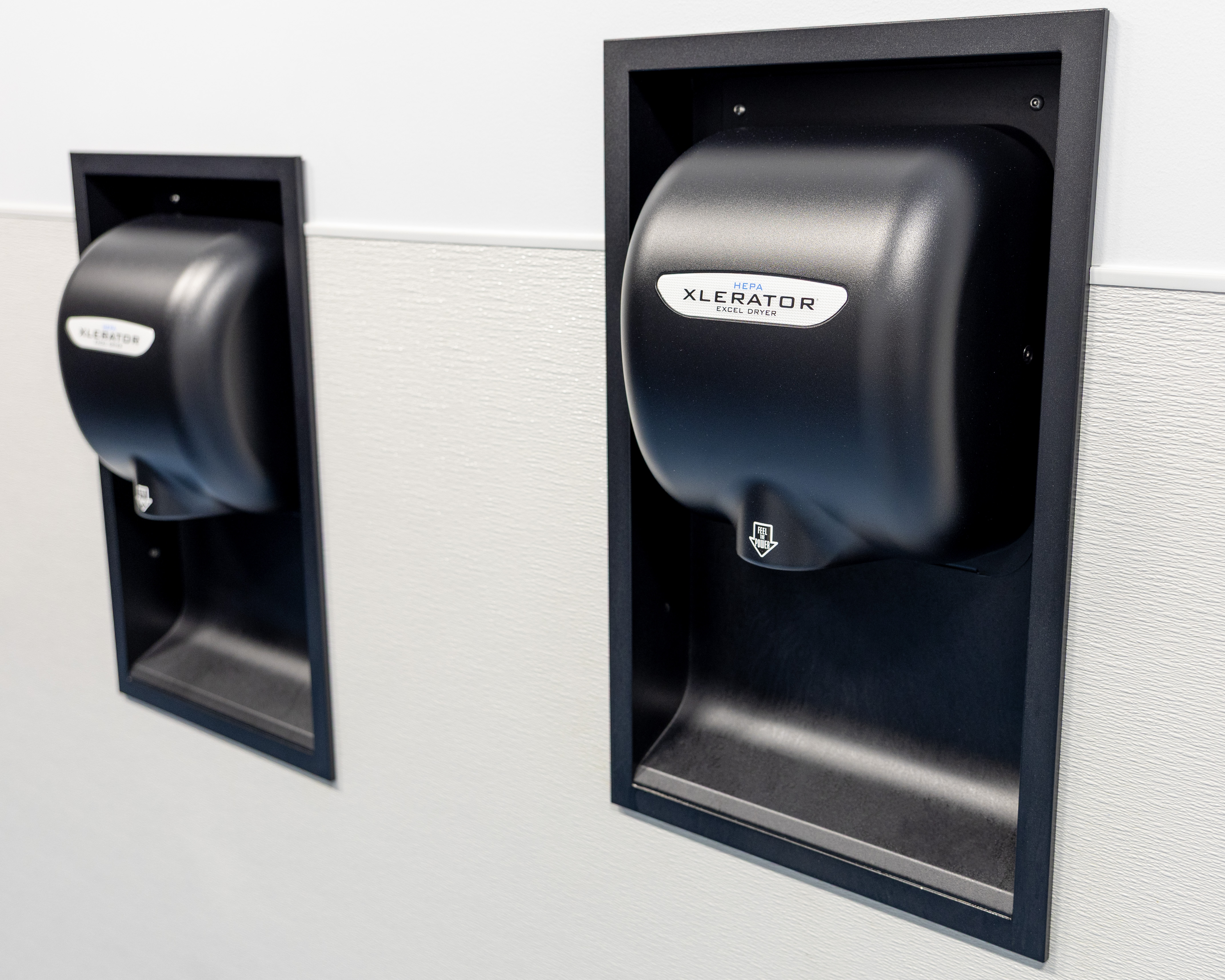 Excel XLERATOR hand dryer in commercial restroom