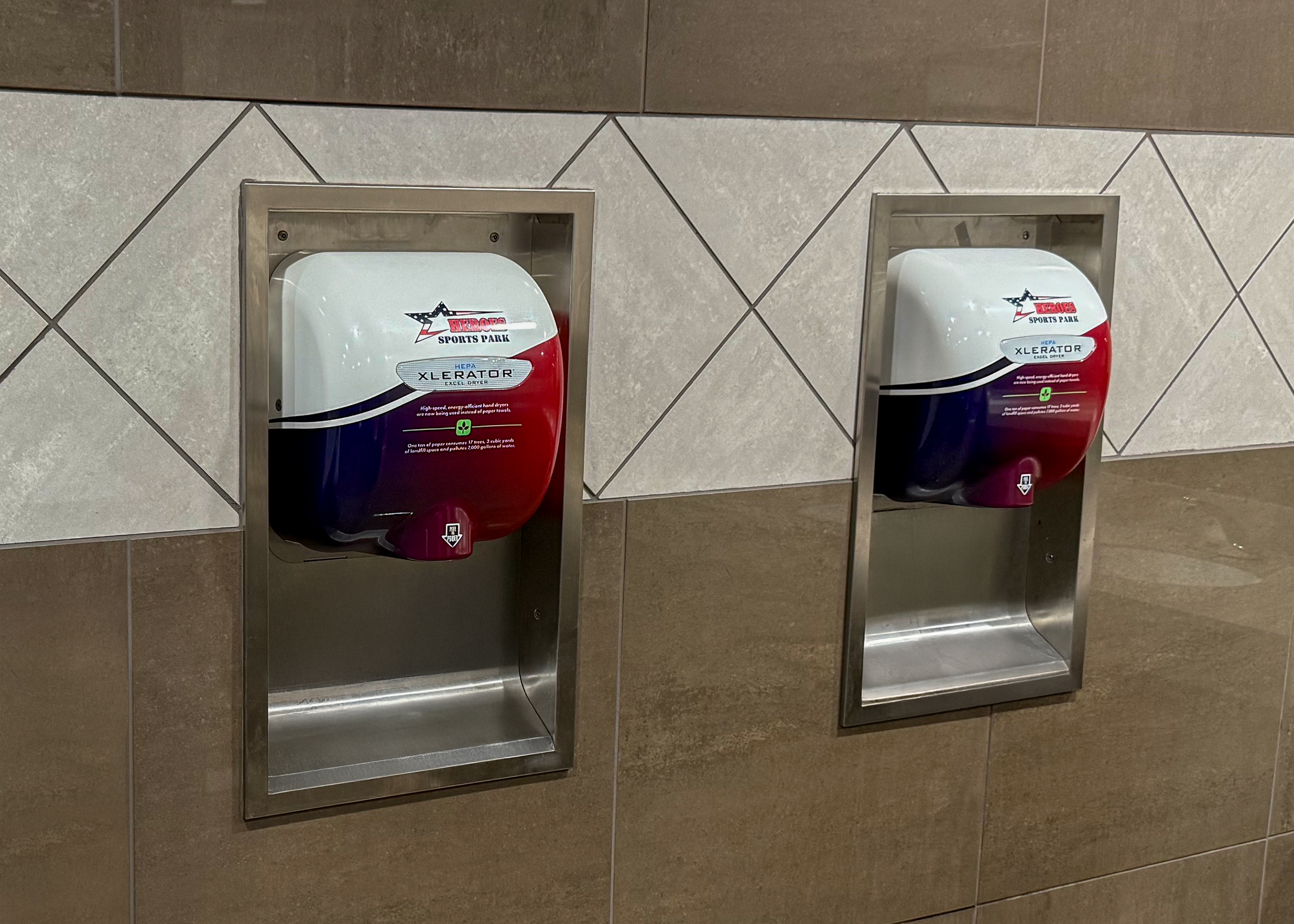 Commercial hand dryer installation in modern tile restroom